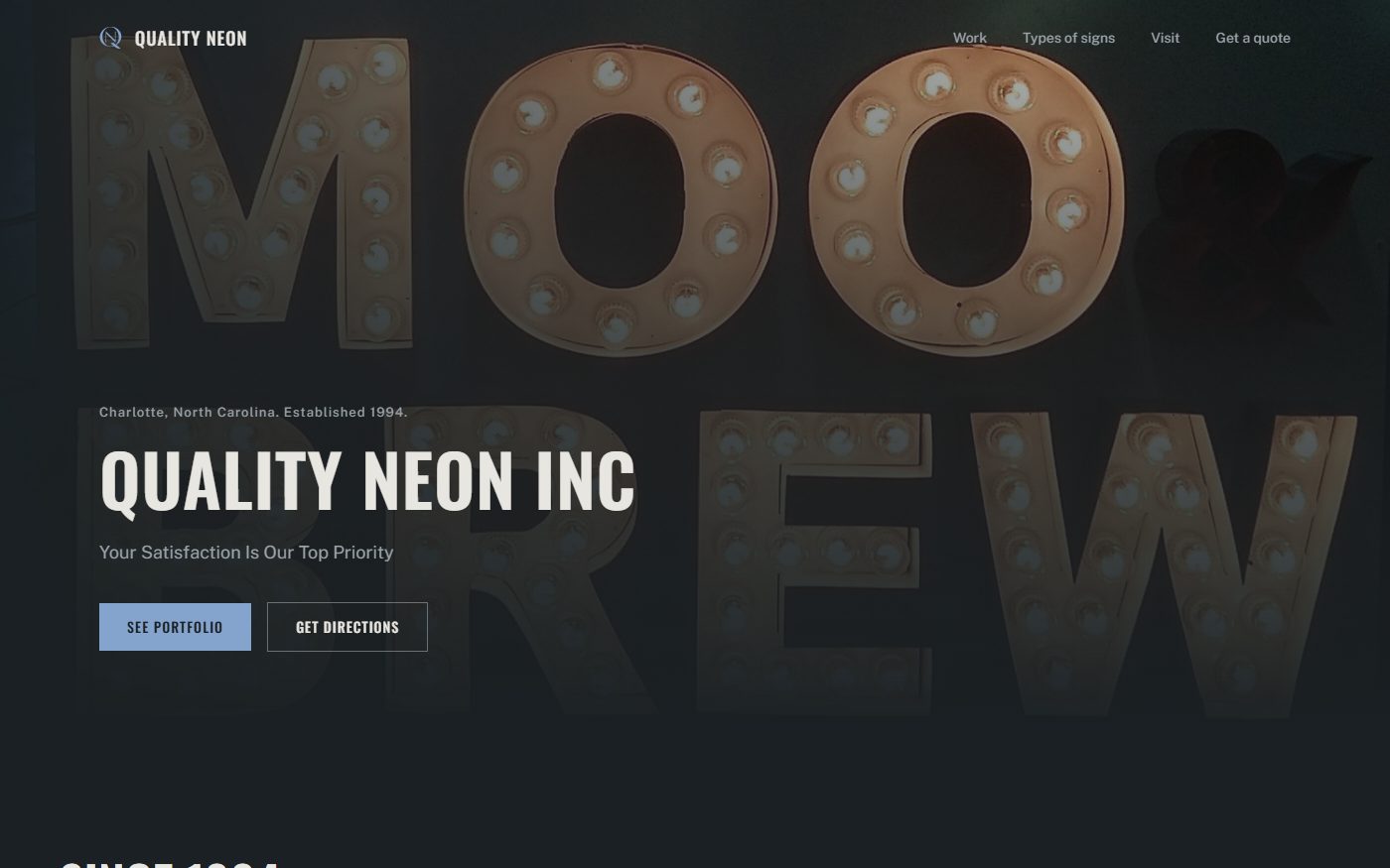 Homepage of the Quality Neon site, a dark slate page with a pale blue accent, with the company name set over a bulb lit marquee sign